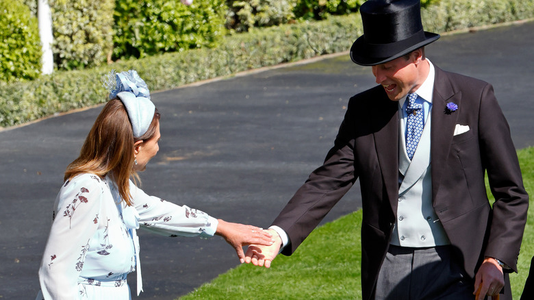 Prince William holding Carole Middleton's hand