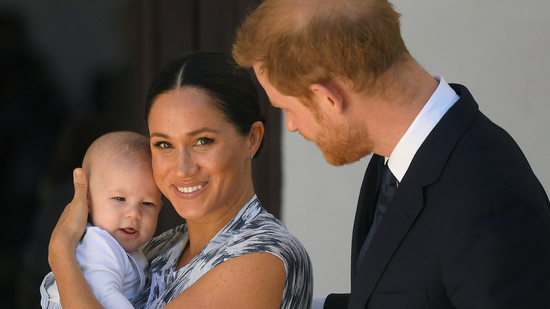 Harry with Meghan, holding Archie 