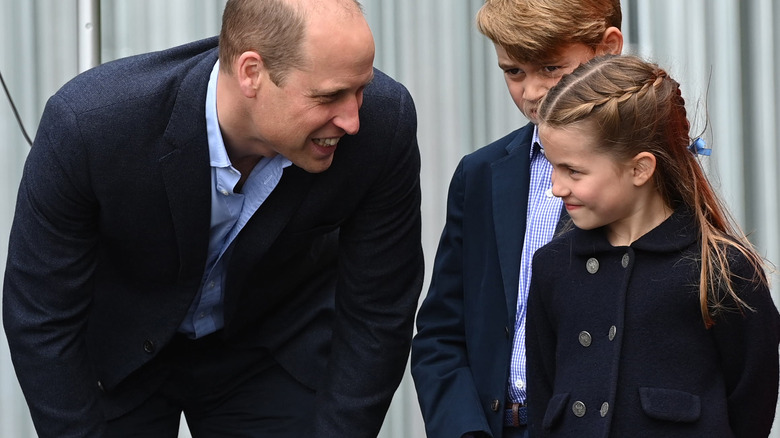 Prince William smiling at Princess Charlotte
