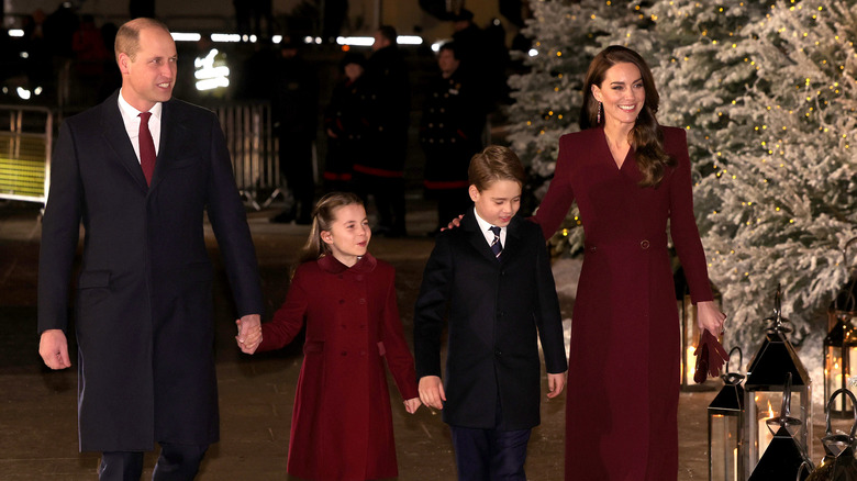 Prince William holding Princess Charlotte's hand