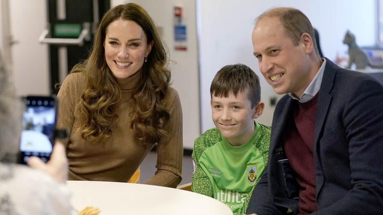 Catherine Middleton and Prince William smiling with Deacon Glover