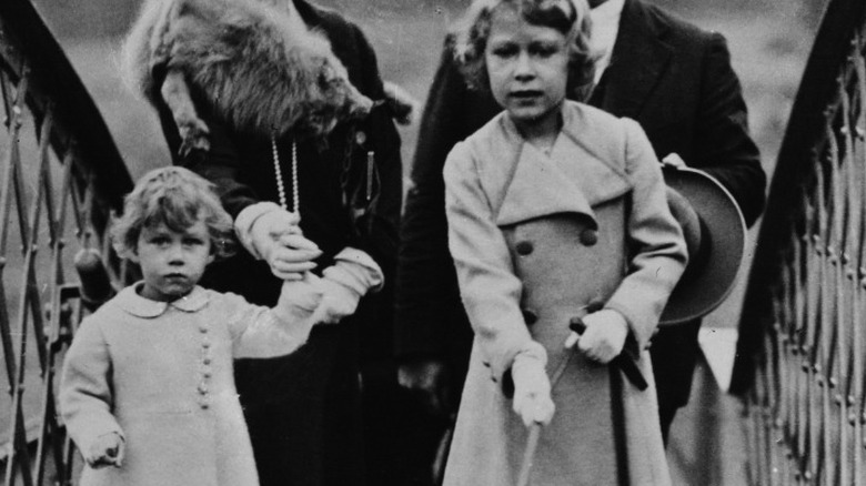 Young Queen Elizabeth walking with Princess Margaret