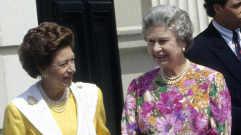 Queen Elizabeth standing with Princess Margaret