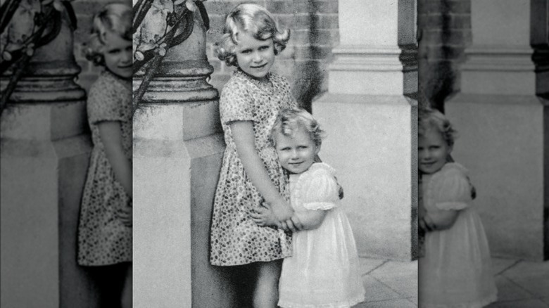 Young Queen Elizabeth embracing Princess Margaret