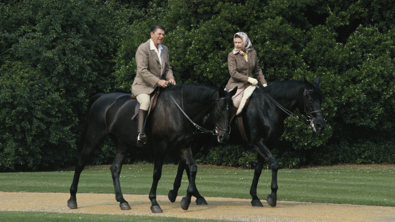 Queen Elizabeth riding horses with Ronald Reagan