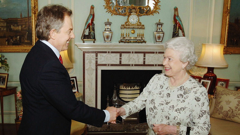 2005, Tony Blair and Queen Elizabeth shaking hands