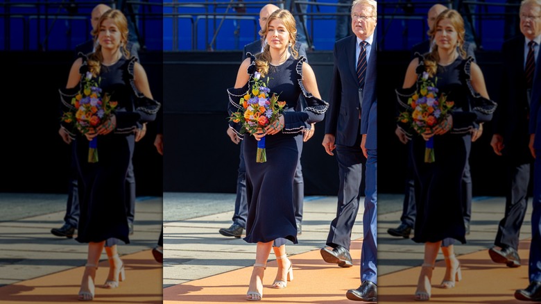 Princess Alexia walking holding flowers