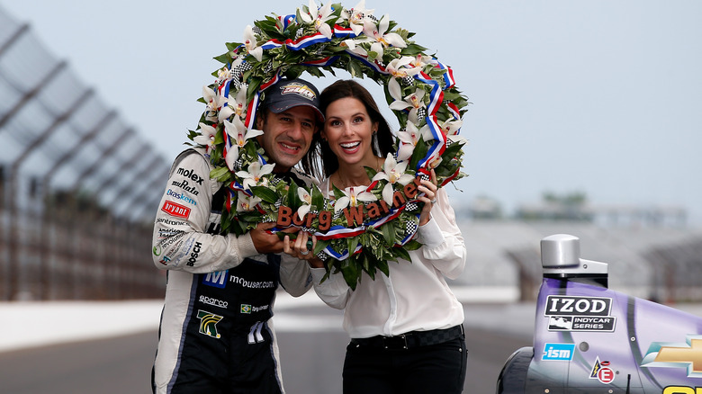 Tony Kanaan and wife Lauren holding a wreath