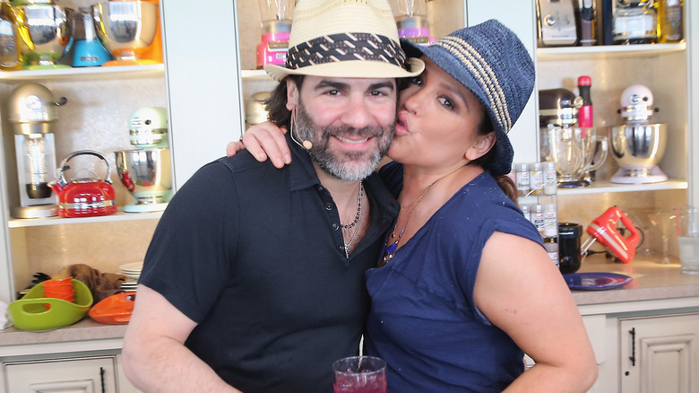 Rachael Ray kissing her husband John