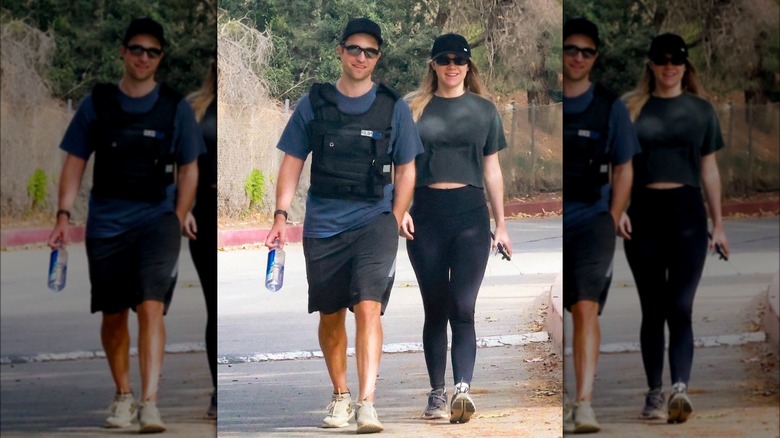 Suki Waterhouse and Robert Pattinson walking 