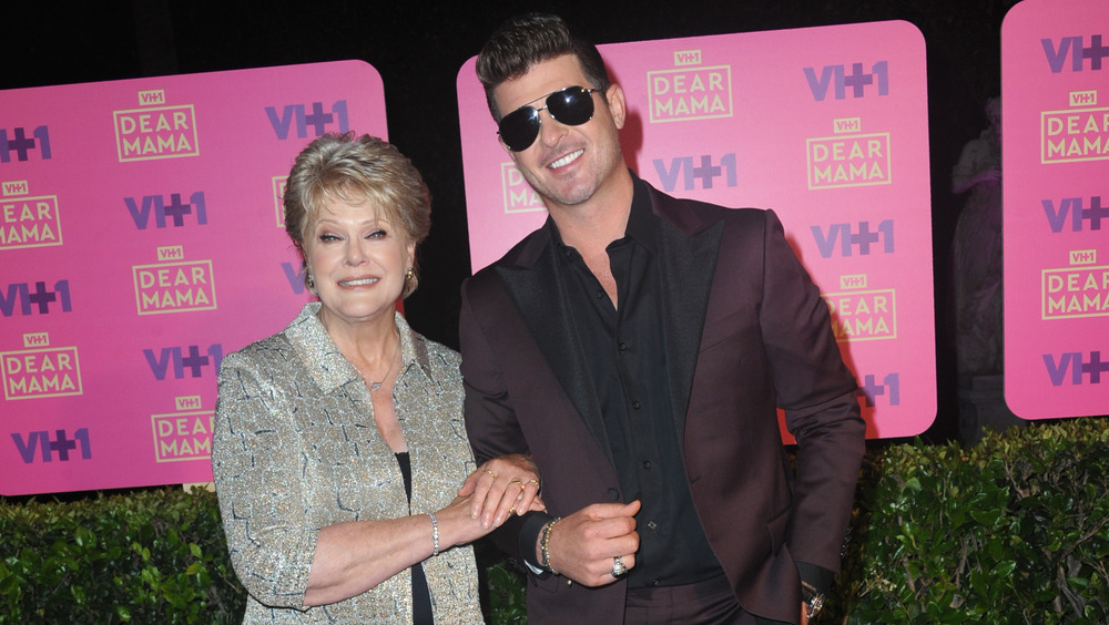 Robin Thicke and Gloria Loring smiling at event