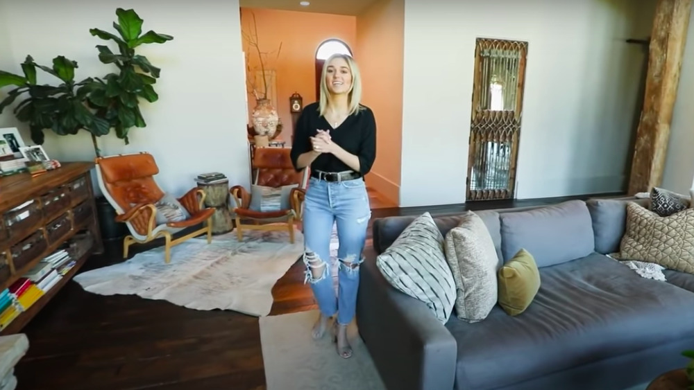 Sadie Robertson standing in the living room of her home