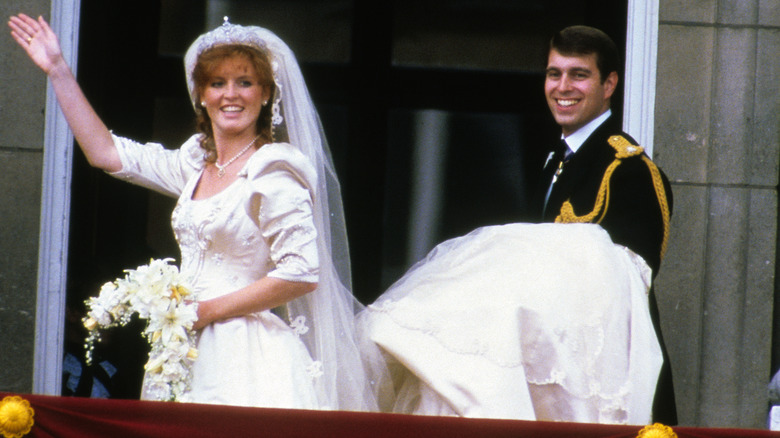 Prince Andrew holds Sarah Ferguson's wedding dress