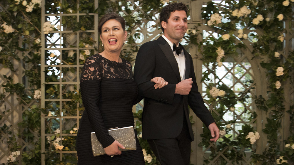 Sarah Huckabee Sanders and husband Bryan Sanders walking into an event with linked arms