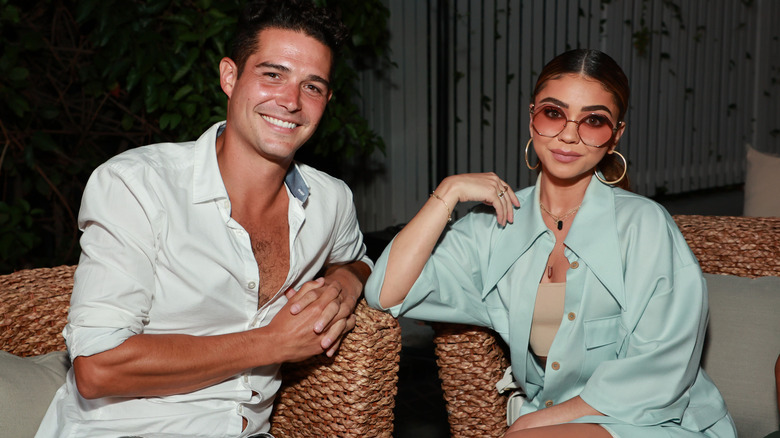 Sarah Hyland and Wells Adams posing for photos