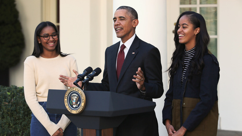 Sasha, Barack and Malia Obama smiling