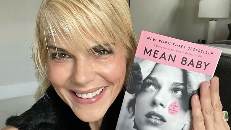 Selma Blair holding her memoir 