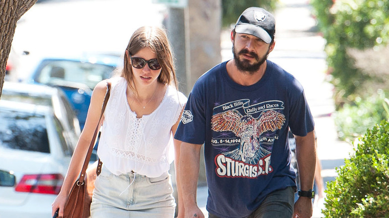 Mia Goth and Shia LaBeouf walking