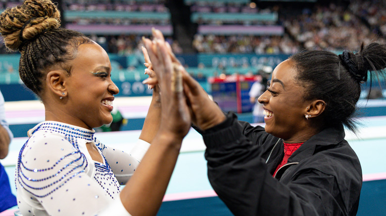 Simone Biles and Rebeca Andrade high-fiving