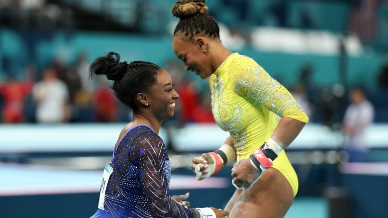 Rebeca Andrade & Simone Biles laughing during competition