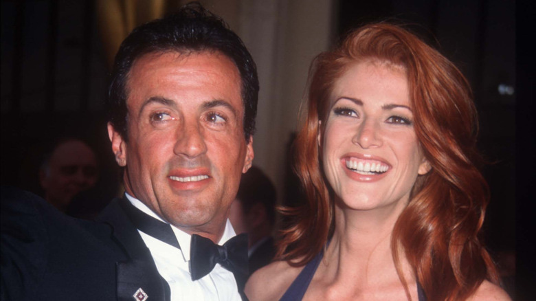 Sylvester Stallone and Angie Everhart smiling at an event