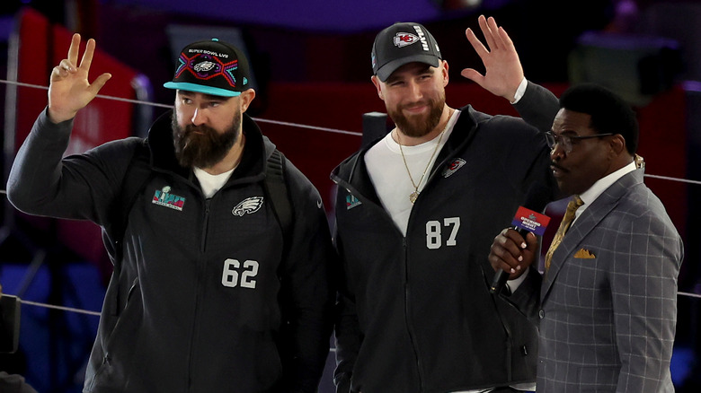 Jason Kelce and Travis Kelce waving to crowd