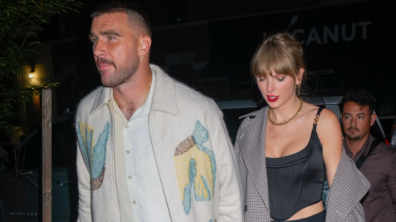 Taylor Swift and Travis Kelce holding hands