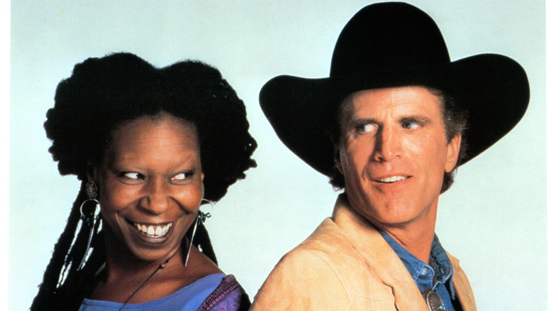 Ted Danson and Whoopi Goldberg standing back to back