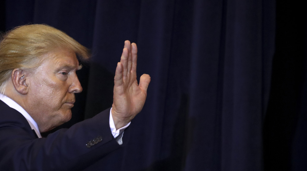 Solemn Donald Trump waving