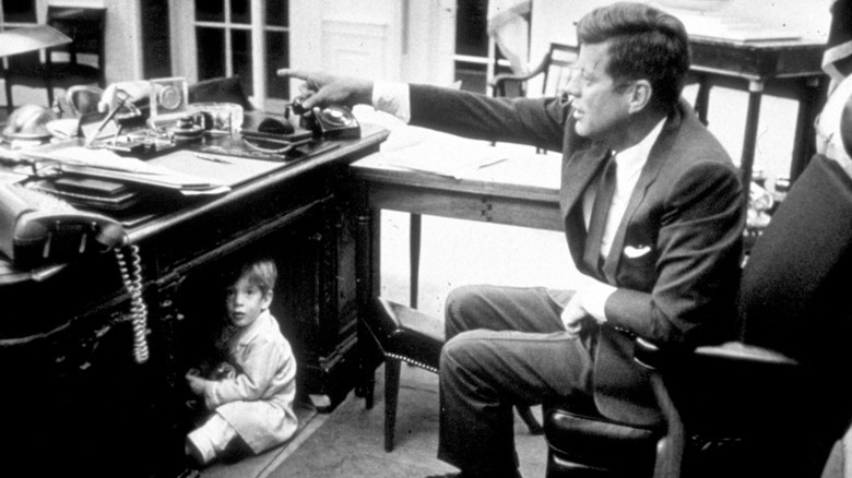 JFK Jr. plays under JFK's Oval Office desk