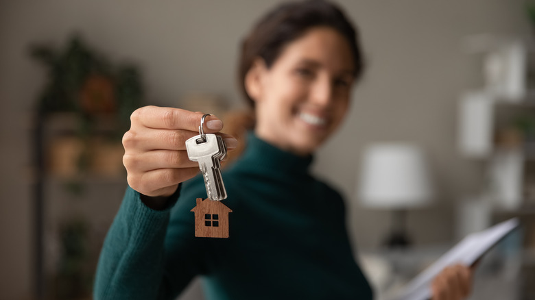 A woman holding house keys