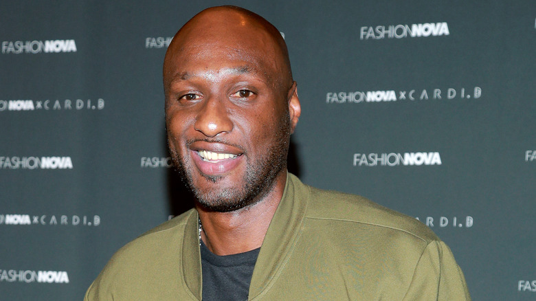 Lamar Odom smiles at an event