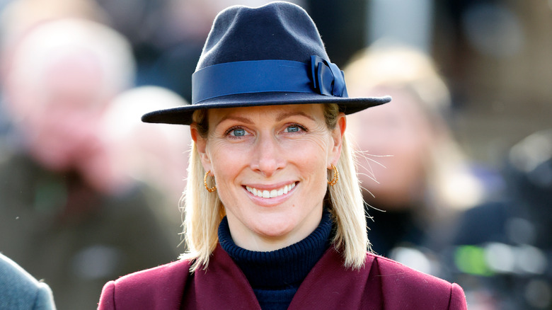 Zara Tindall smiling in blue hat