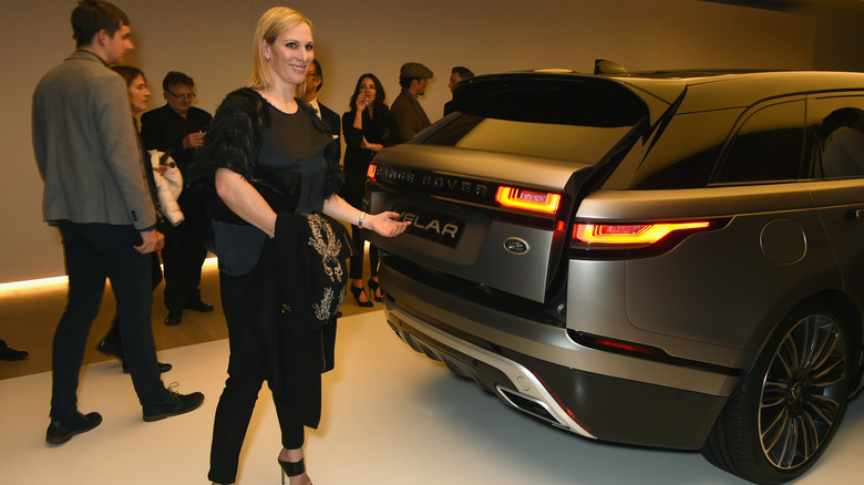 Zara Tindall posing by a Range Rover