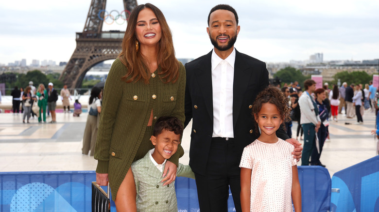 Chrissy Teigen and John Legend with their kids at the opening ceremony of the Paris Olympic Games in 2024