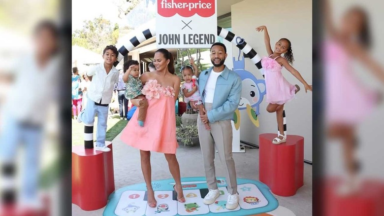 John  Legend and Chrissy Teigen with their kids at a Fisher-Price event in 2024