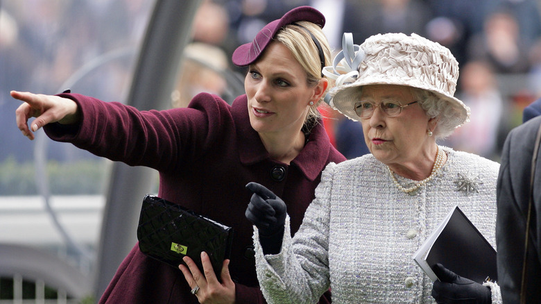 Zara Tindall pointing at something with the Queen