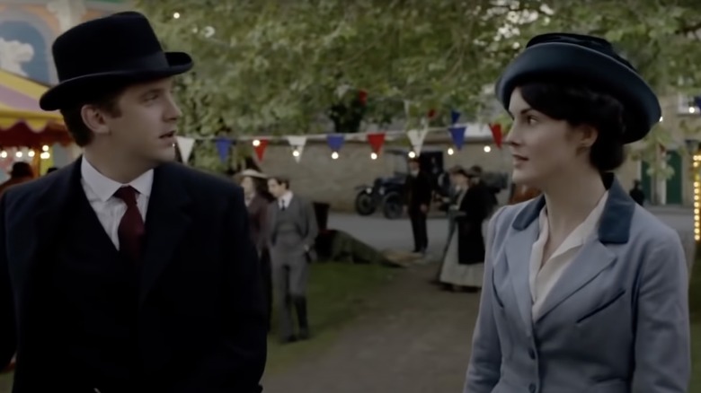 Dan Stevens as Matthew Crawley and Michelle Dockery as Mary Crawley filming a scene on the green in Downton Abbey