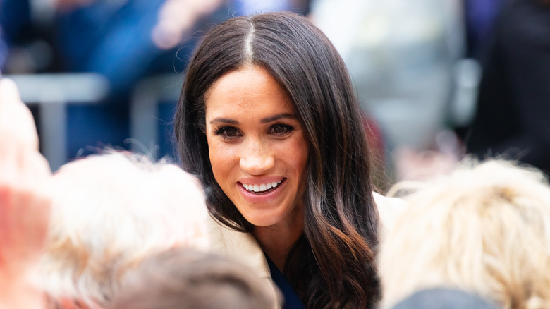 Meghan Markle smiling at crowd