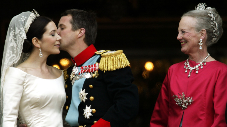 Queen Margrethe beams as her son kissed Mary on their wedding day