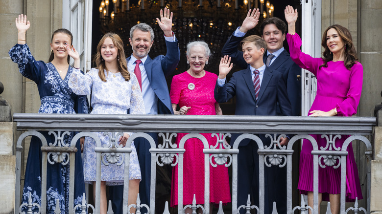 Mary and Frederik with their kids and Queen Margrethe waving