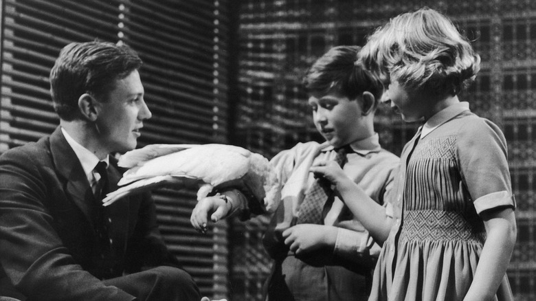 David Attenborough, Prince Charles, and Princess Anne with cockatoo