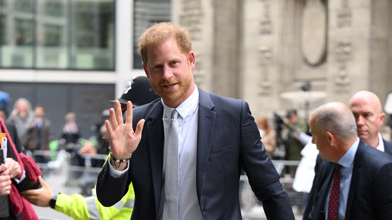 Prince Harry arriving at court, waving