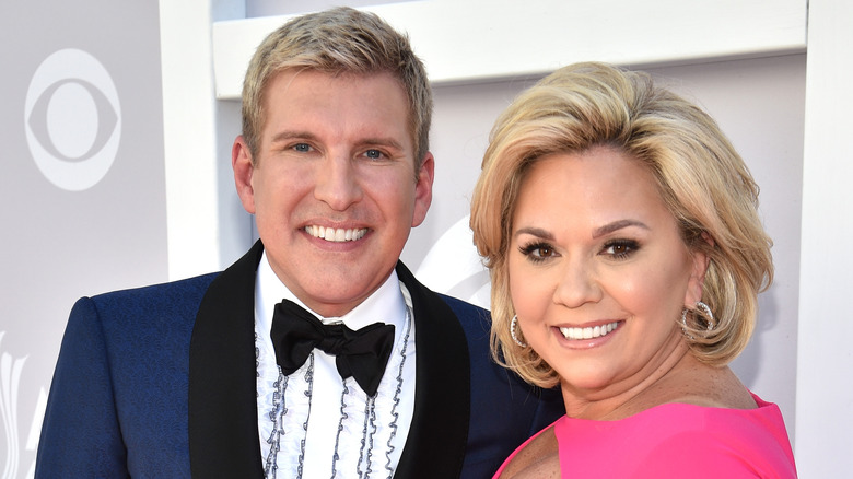 Todd and Julie Chrisley smiling on the red carpet