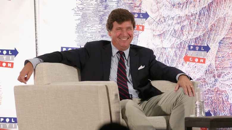 Tucker Carlson smiling at event