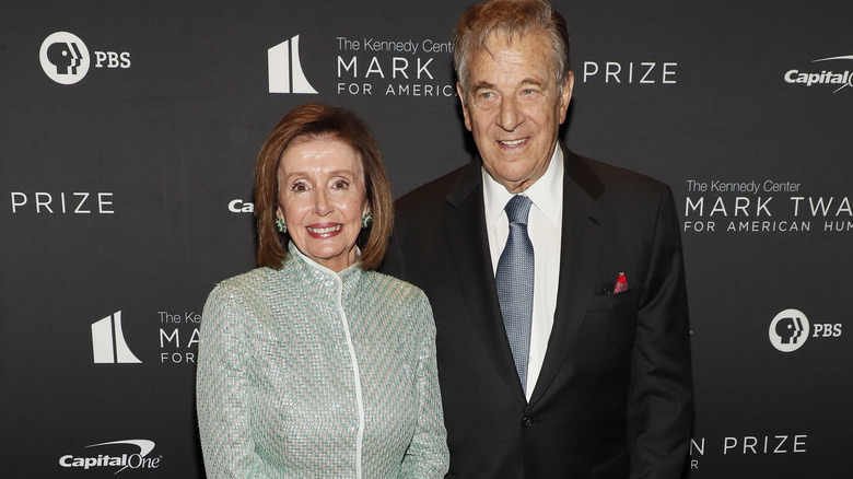 Nancy Pelosi and Paul Pelosi smiling at an event