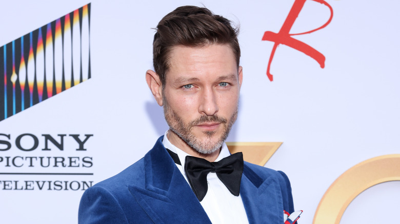 Michael Graziadei wearing a blue suit at an event