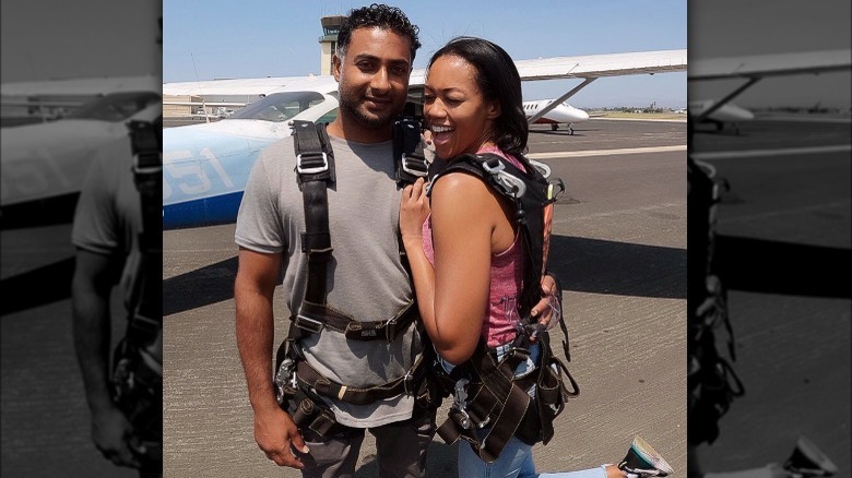 Mishael Morgan and Navid Ali standing in front of an airplane