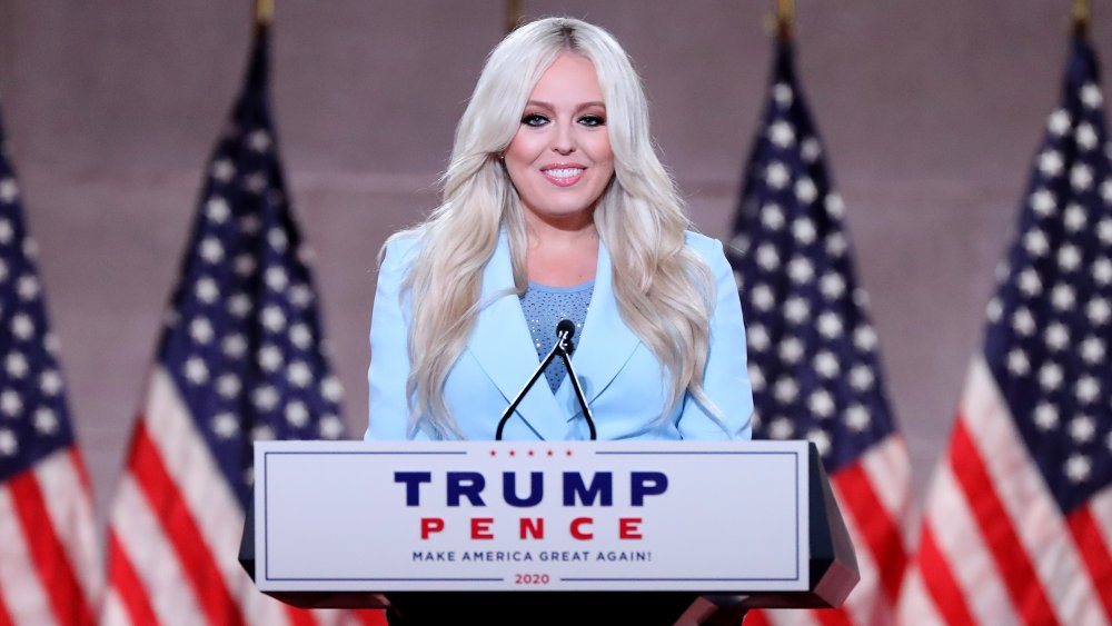 Tiffany Trump at a podium with flags in the background