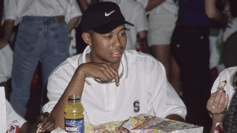 Tiger Woods with food wrappers in front of him